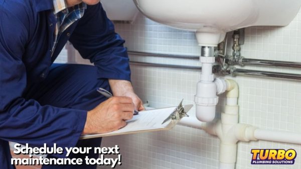 A plumber in blue coveralls inspects and notes items on a plumbing maintenance checklist beneath a sink; Turbo Plumbing Solutions logo and scheduling message appear in the image.