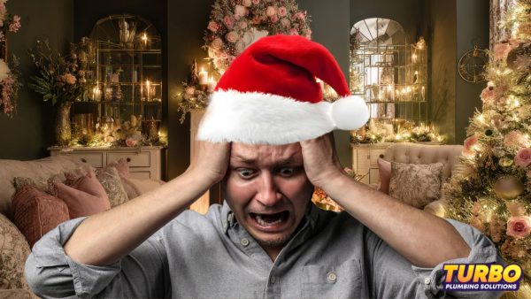 A man wearing a Santa hat holds his head and looks distressed in a festively decorated room, worried about Christmas disasters; Turbo Plumbing Solutions logo is visible in the corner.